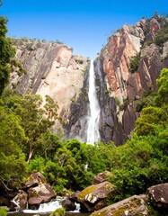 Waterfall cascading down rocky cliff