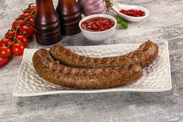 Grilled beef sausages with sauce
