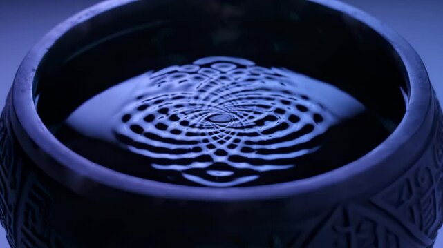 Serene Water Ripples Creating Hypnotic Patterns in a Dark Bowl
