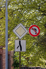 European Priority Road Sign Straight with Side Road Left Down and No Left Turn