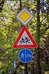 European Priority Road Sign with Children Warning and Shared Pedestrian Bicycle Path Sign