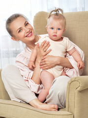 Mother and baby playing and smiling. Happy family.Home interior.