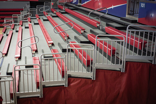 Red cushioned bleacher seats with gray safety rails, visible section signage. Team banners, seating gaps highlight thoughtful stadium planning, inclusive college design features in Dallas, Texas