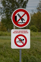 European Prohibition Signs No Diving and No Swimming with Latvian Text Laivu Akvatorijā Peldēties Aizliegts