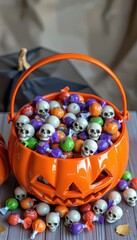 Festive Halloween Pumpkin Bucket Filled with Colorful Candy and Skull Decorations