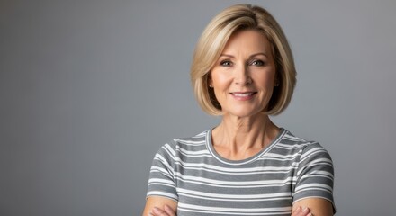Portrait of a smiling middle-aged woman with short blonde hair wearing a striped shirt