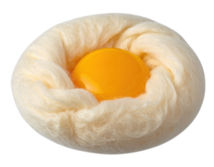 Bright yellow egg yolk sitting inside a fluffy cotton candy nest, creating a surreal and creative food art concept on black background.