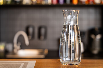 Glass carafe of water on wooden counter