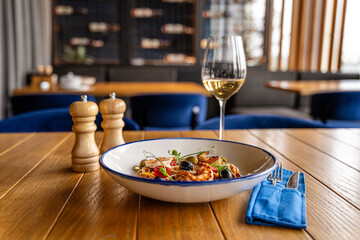 Pasta with wine in elegant restaurant setting