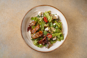Top view of salad with smoked eel and greens