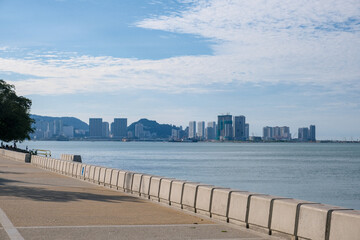 View of Penang Esplanade seafront promenade with the modern George Town skyline in the background....