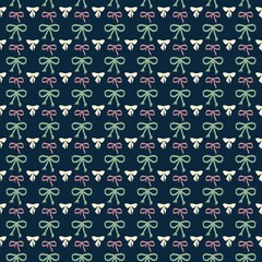 Pattern of festive bows arranged in a neat grid design on a dark background for seasonal decoration. Seamless background