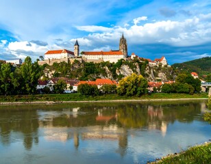 Panoramic view of a medieval city reflected in a river