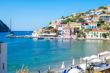 Sunny Day at Assos Village: Wide View of the Harbor, Colorful Waterfront Buildings, and Beach Activities, Kefalonia