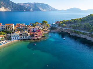 Aerial View of Assos Village and Beach: Colorful Waterfront Buildings and Turquoise Cove in Kefalonia