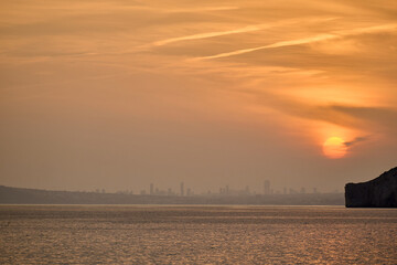 Serene sunset calm Mediterranean waters golden reflection peaceful seascape Calpe Spain horizontal composition romantic evening atmosphere
