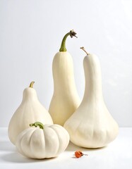 Four white pumpkins in a studio setting