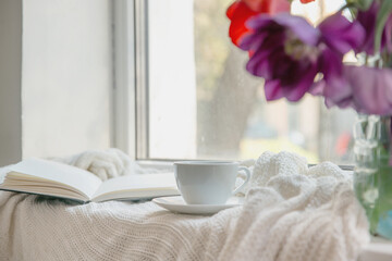 White cup on the window.