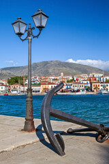 Galaxidi town, Greece, Europe. View of the traditional village at the background, with a lamp post and an anchor, symbol of its maritime tradition
