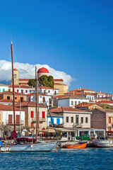 Galaxidi town under tense white clouds, view of the fishing port of this old, traditional village, built by the sea at the Corinthian Gulf, in Greece.