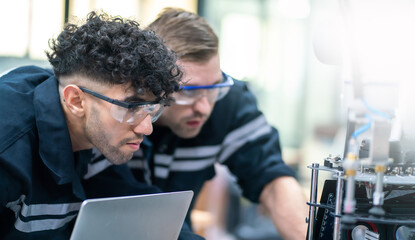 Mechanical engineering team working in robotic technology lap for research and develop for manufacturing automation and robotics.