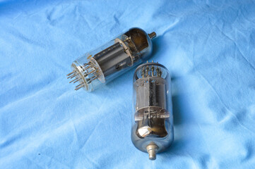 vintage vacuum tubes on blue background, retro electronic components used in radios and amplifiers,...