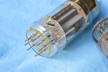 vintage vacuum tubes on blue background, retro electronic components used in radios and amplifiers,...