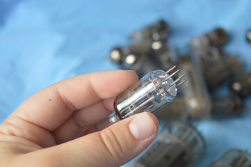 vintage vacuum tubes on blue background, retro electronic components used in radios and amplifiers,...
