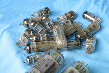 vintage vacuum tubes on blue background, retro electronic components used in radios and amplifiers,...
