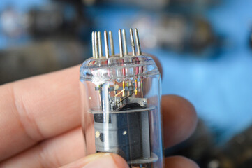 vintage vacuum tubes on blue background, retro electronic components used in radios and amplifiers,...