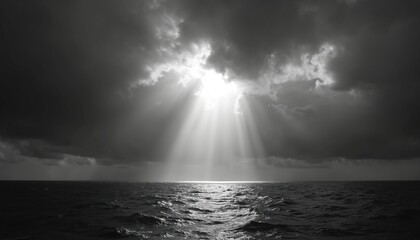 Dark storm clouds fill sky over calm ocean water. Bright sun rays break through gloomy clouds, lighting up sea surface. Horizon line visible on grey monochrome seascape. Light beams reflect on waves,