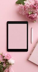 Tablet, stylus, flowers, and book on pink backdrop