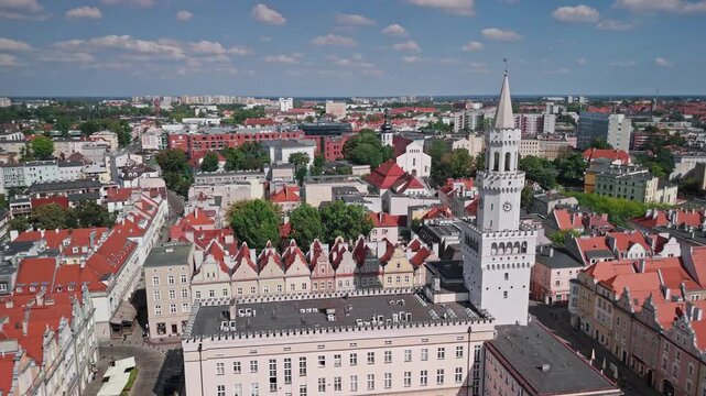 Aerial view of Opole city center: a orbiting drone shot revealing the Market Square, with Na Gorce Church and the University of Opole in the background, Poland