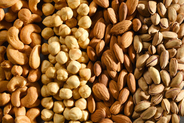 Pistachio nuts in a wooden bowl isolated on white background