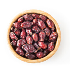 Dried wild rose berries in wooden bowl isolated on white background with clipping path