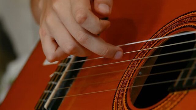 Child with motor disablilities while doing guitar practice lessons at home, music therapy, 4k