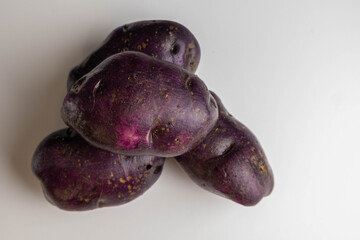 Vitellote potatoes. Raw unpeeled purple potatoes. Healthy food for diabetics, starch-free.