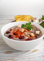 Healthy food for diabetics, starch-free. Purple potato cream soup. A nice composition with seasonings and berries.