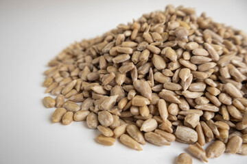 shelled sunflower seeds on a white background