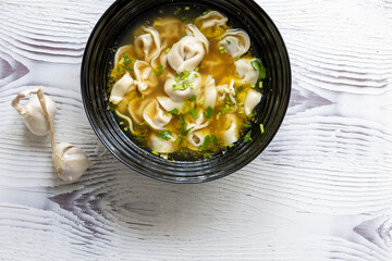 Close-Up of Molo Soup in a Black Bowl – Traditional Filipino Dish
