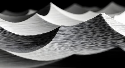 Abstract closeup of wavy white paper sheets creating a textured pattern with dramatic lighting and shadows