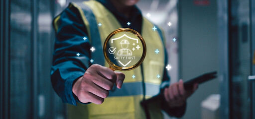 Engineer promoting safety first with digital interface and icon in industrial environment,...