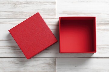 Red gift box on a wooden surface: A vibrant red gift box, its lid ajar, rests upon a textured wooden surface, revealing its empty interior. A modern display of simplicity and openness.