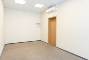 Minimalist Interior of an Empty Room With Beige Walls and Wooden Door. 
