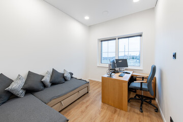 Modern Home Office Interior with Comfortable Seating and Large Window View