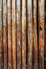 Vertical wooden wall background with rustic texture and natural cracks. Perfect for abstract, design, or vertical layout projects.