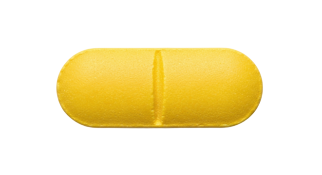 Isolated yellow oblong pill, close-up view of pharmaceutical tablet or vitamin capsule