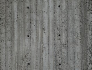 Gray cement wall background with holes. Construction and renovation concept. Space for creative text and advertising.