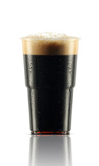 a plastic mug with drops of dark beer