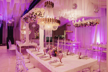 elegant table decorated with a large lamp and plates and purple flowers